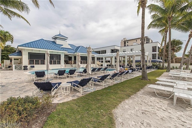 view of property's community featuring a swimming pool, a pergola, and a patio area