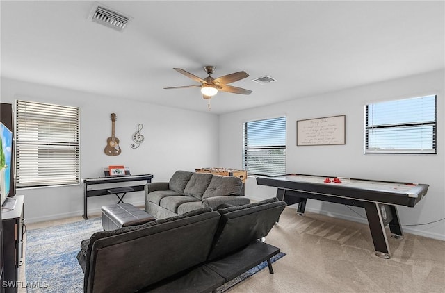living room with a ceiling fan, baseboards, and visible vents