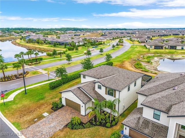 birds eye view of property with a water view and a residential view