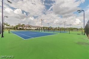 view of tennis court with fence