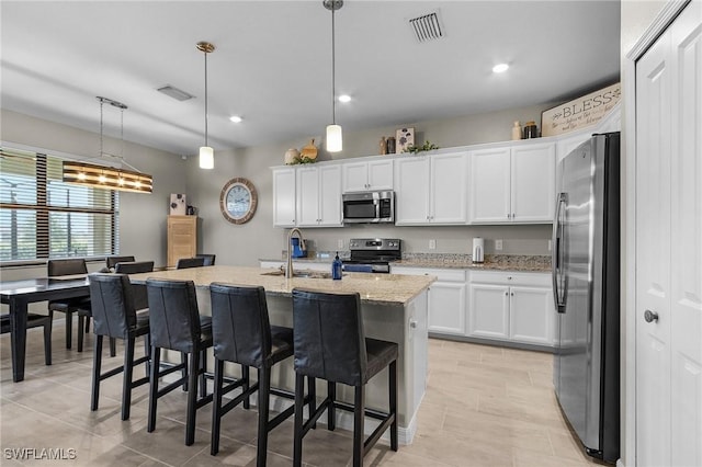 kitchen featuring a sink, white cabinetry, visible vents, and appliances with stainless steel finishes
