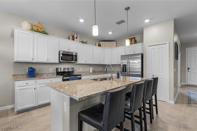 kitchen featuring a sink, visible vents, white cabinets, baseboards, and appliances with stainless steel finishes
