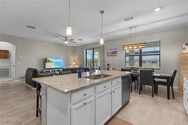 kitchen with a sink, white cabinets, visible vents, and dishwasher
