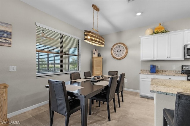 dining space with light tile patterned floors and baseboards