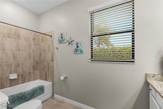 bathroom featuring toilet, baseboards, vanity, and plenty of natural light
