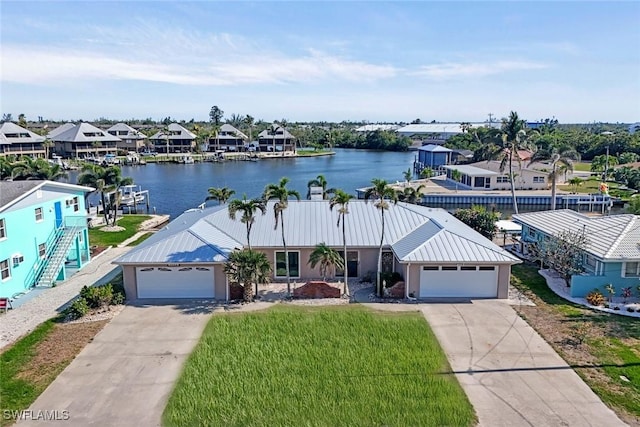 view of front of property with a water view, driveway, and stucco siding