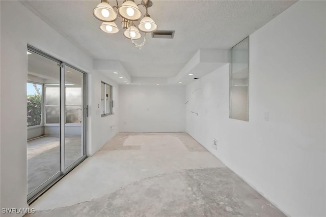 spare room featuring an inviting chandelier, recessed lighting, visible vents, and unfinished concrete flooring