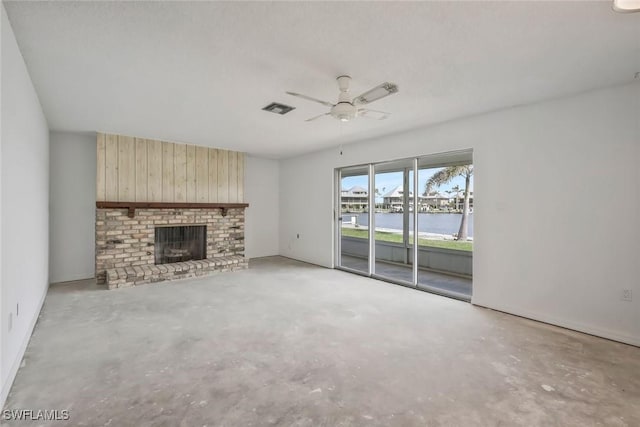 unfurnished living room with a ceiling fan, concrete floors, a brick fireplace, and visible vents