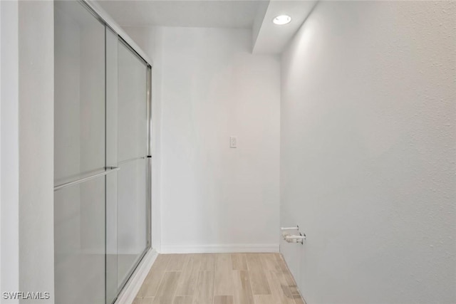 hall with recessed lighting, baseboards, and light wood-type flooring