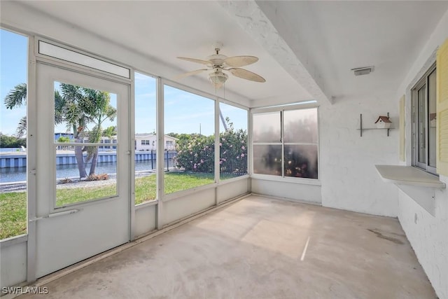 unfurnished sunroom with a water view, ceiling fan, visible vents, and beamed ceiling