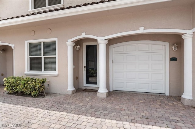 4938 Viceroy St Unit 107, Cape Coral, FL 33904 - view of exterior entry featuring decorative driveway and stucco siding