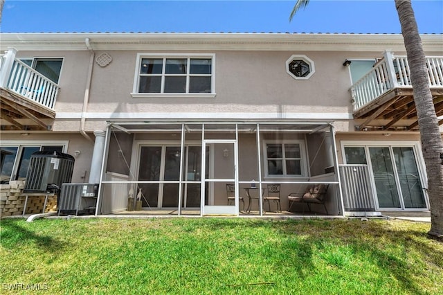 4938 Viceroy St Unit 107, Cape Coral, FL 33904 - rear view of house featuring a yard, a balcony, a sunroom, and stucco siding