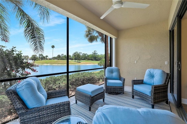 sunroom with a water view, ceiling fan, and an outdoor living space