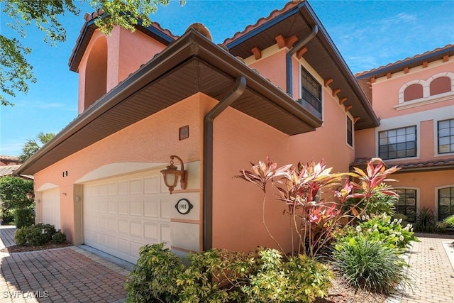 view of home's exterior featuring driveway and stucco siding