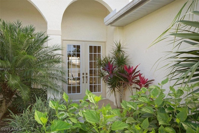 1725 SE 10th Pl, Cape Coral, FL 33990 - doorway to property with stucco siding and french doors