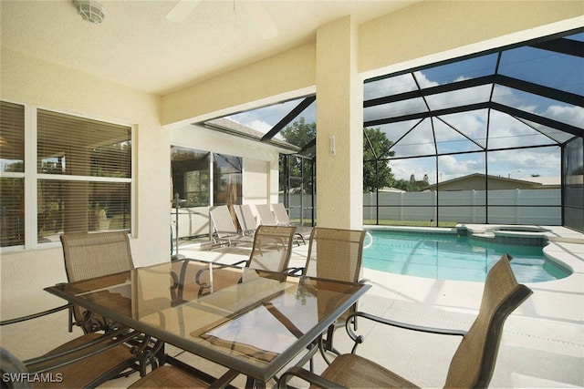 1725 SE 10th Pl, Cape Coral, FL 33990 - view of swimming pool featuring glass enclosure, a pool with connected hot tub, and a patio area