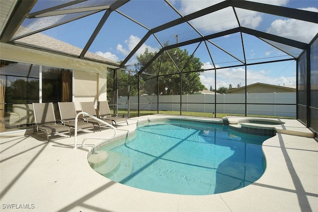 1725 SE 10th Pl, Cape Coral, FL 33990 - view of pool with glass enclosure, a patio, a pool with connected hot tub, and fence