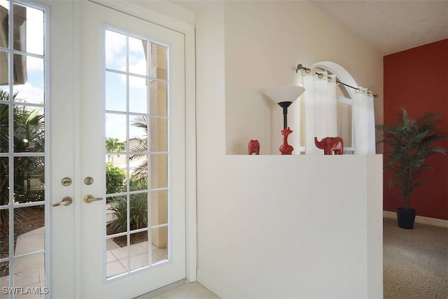 1725 SE 10th Pl, Cape Coral, FL 33990 - doorway with baseboards, french doors, carpet flooring, and a wealth of natural light