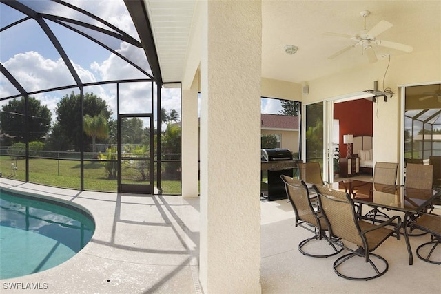 1725 SE 10th Pl, Cape Coral, FL 33990 - outdoor pool featuring a ceiling fan, glass enclosure, and a patio area