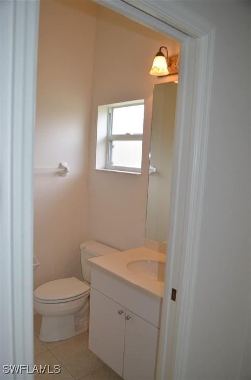 1725 SE 10th Pl, Cape Coral, FL 33990 - half bath featuring toilet, tile patterned flooring, and vanity