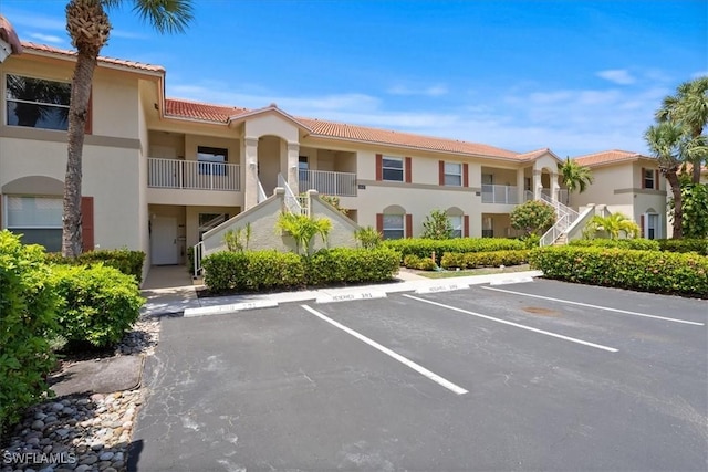 6645 Huntington Lakes Cir Unit 202, Naples, FL 34119 - view of property featuring uncovered parking and stairs
