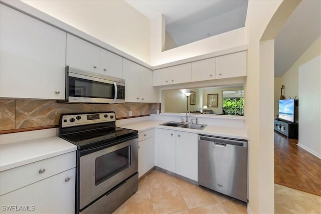 6645 Huntington Lakes Cir Unit 202, Naples, FL 34119 - kitchen with a sink, light countertops, backsplash, and stainless steel appliances