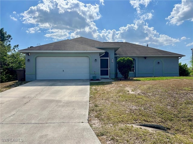 ranch-style house featuring an attached garage, stucco siding, and driveway