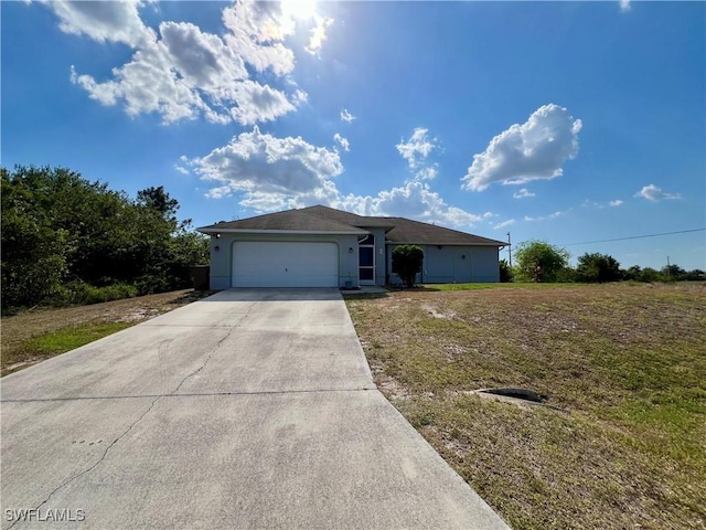 single story home with an attached garage, stucco siding, driveway, and a front lawn
