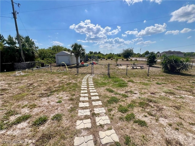 view of yard featuring a garage and fence