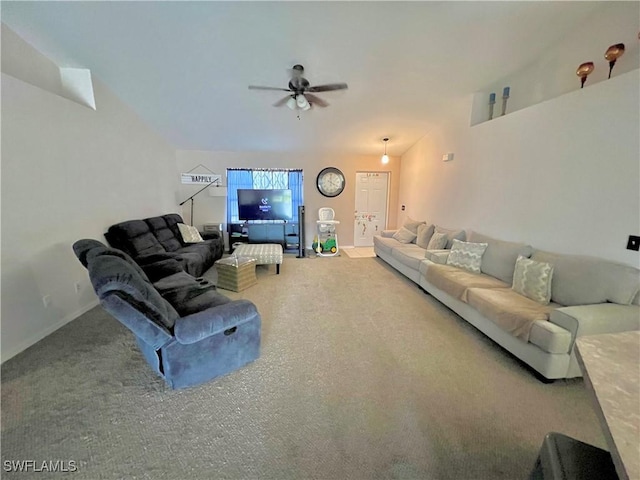 carpeted living area with baseboards and ceiling fan