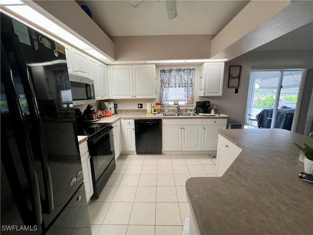 kitchen with white cabinetry, a sink, light tile patterned floors, and black appliances