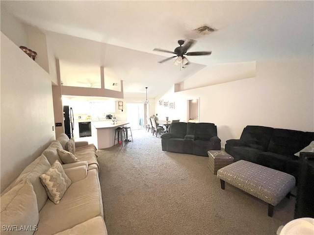 carpeted living area featuring visible vents, ceiling fan, and vaulted ceiling