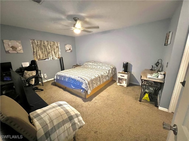 carpeted bedroom with baseboards, a ceiling fan, and visible vents