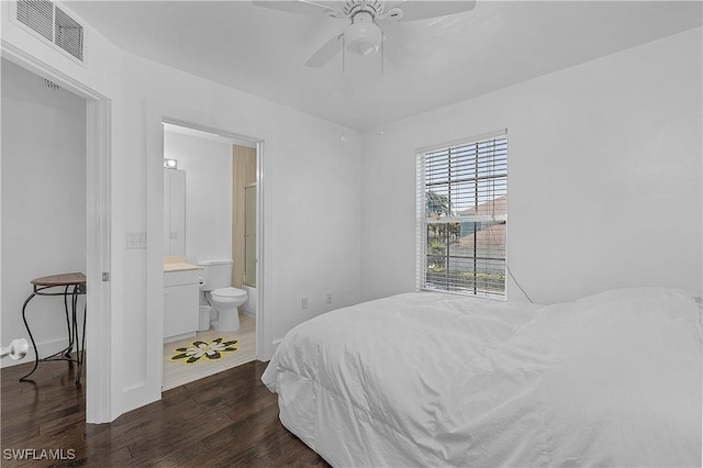 bedroom featuring visible vents, wood finished floors, baseboards, ensuite bathroom, and ceiling fan