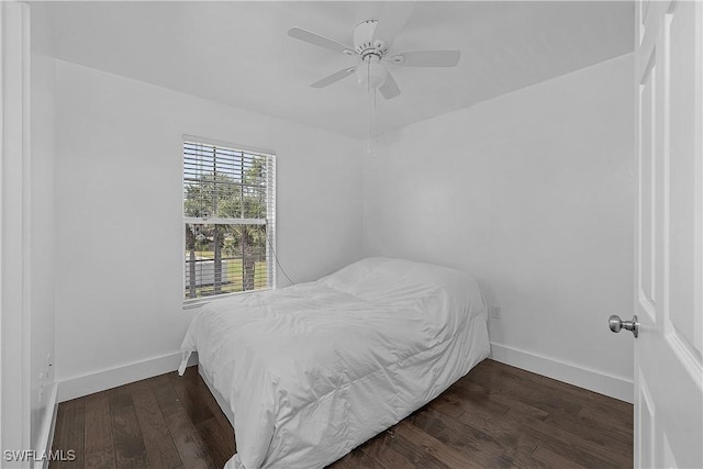 bedroom featuring baseboards, a ceiling fan, and wood finished floors