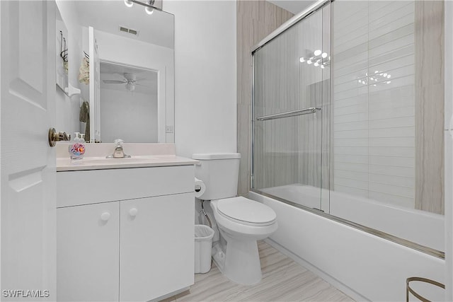 3646 Pine Oak Cir Unit 102, Fort Myers, FL 33916 - bathroom featuring visible vents, vanity, toilet, shower / bath combination with glass door, and a ceiling fan