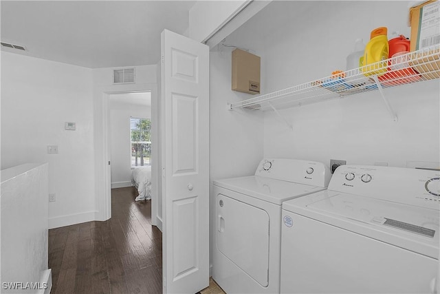 3646 Pine Oak Cir Unit 102, Fort Myers, FL 33916 - washroom with visible vents, laundry area, wood finished floors, washer and dryer, and baseboards