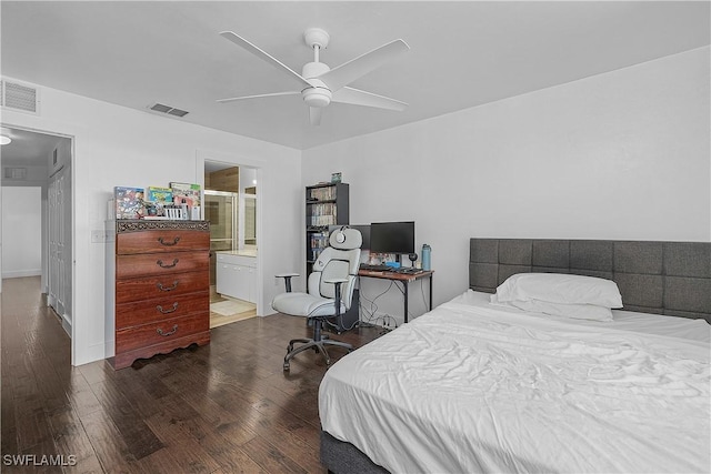 bedroom with visible vents, a ceiling fan, ensuite bathroom, and wood finished floors