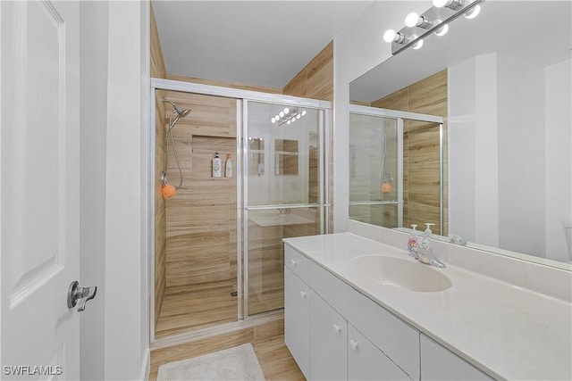 bathroom featuring vanity and a stall shower