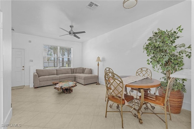 living area featuring a ceiling fan, baseboards, and visible vents