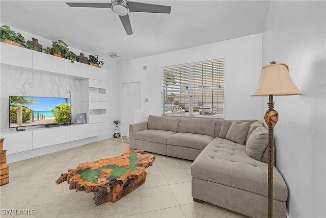 living area featuring ceiling fan and light tile patterned flooring
