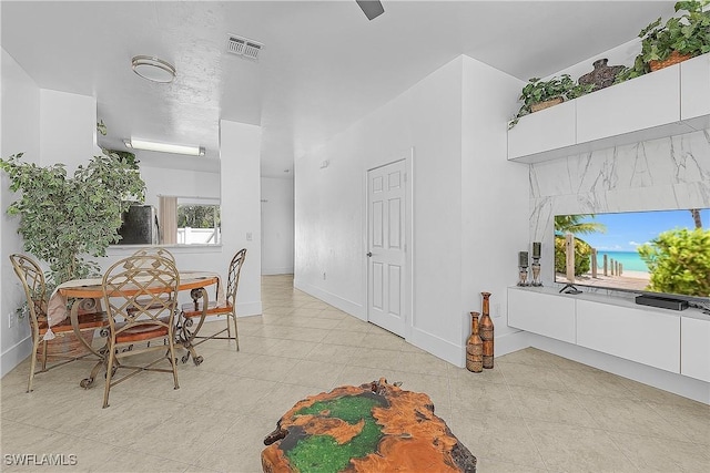 dining room with light tile patterned flooring, baseboards, and visible vents