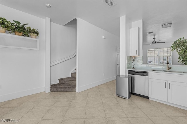 kitchen featuring visible vents, dishwasher, a sink, light countertops, and white cabinetry