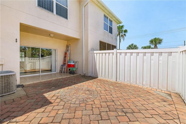 view of patio featuring fence and central AC unit