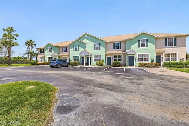 3646 Pine Oak Cir Unit 102, Fort Myers, FL 33916 - view of front of home with uncovered parking and stucco siding