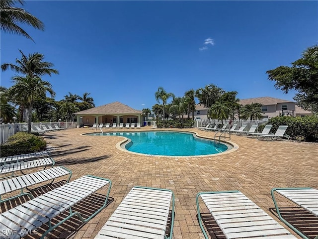 community pool featuring a patio and fence