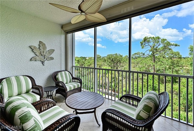 sunroom / solarium featuring ceiling fan