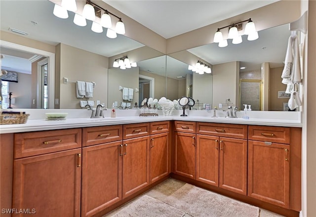 full bath featuring double vanity, visible vents, a sink, and a stall shower