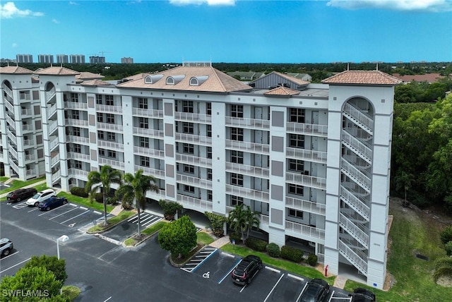 view of property featuring uncovered parking