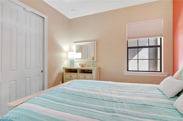 bedroom with crown molding and a closet